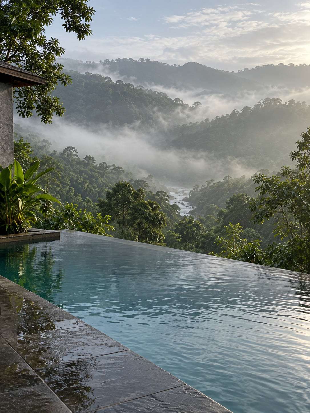 Infinity-edge outdoor pool on a hillside, morning mist over wet-zone forest, Ratnapura District